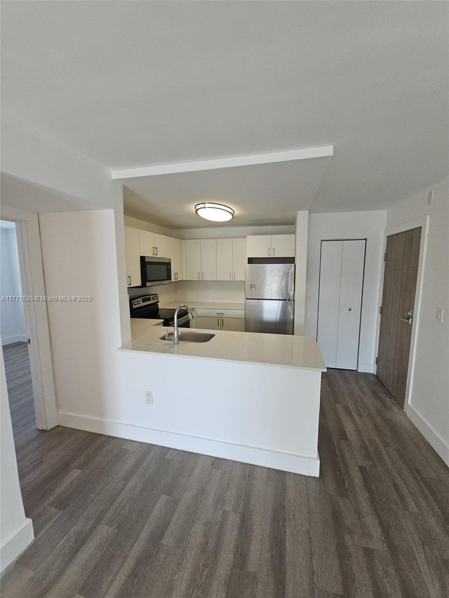 8101 Crespi Boulevard, Unit 304 Miami Beach, FL 33141 - Photo 4 of 25 a view of kitchen with refrigerator sink and cabinets