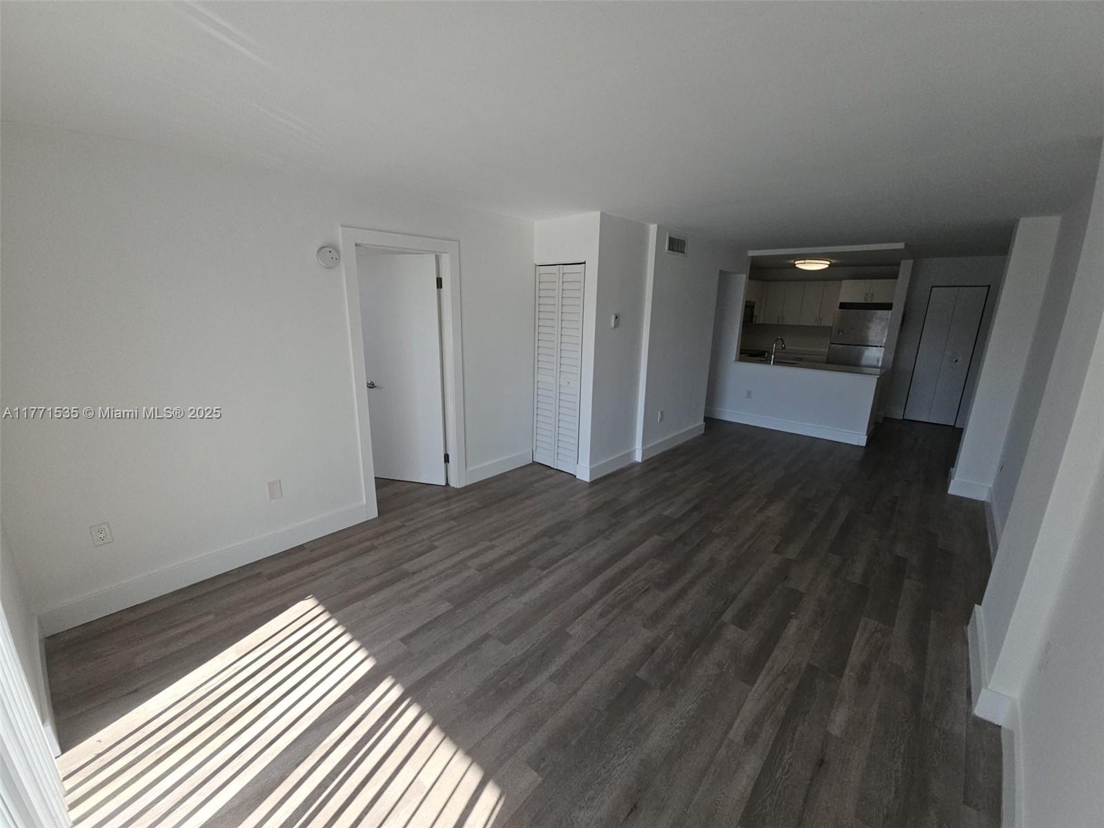 8101 Crespi Boulevard, Unit 304 Miami Beach, FL 33141 - Photo 5 of 25 a view of empty room with wooden floor