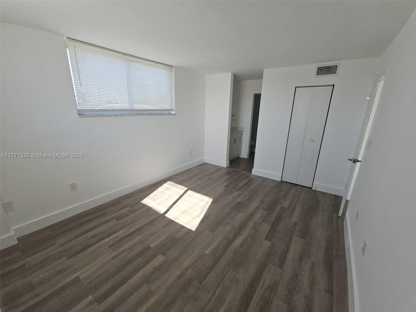 8101 Crespi Boulevard, Unit 304 Miami Beach, FL 33141 - Photo 8 of 25 a view of empty room with wooden floor