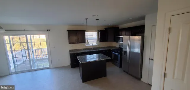 a kitchen with a refrigerator and a sink