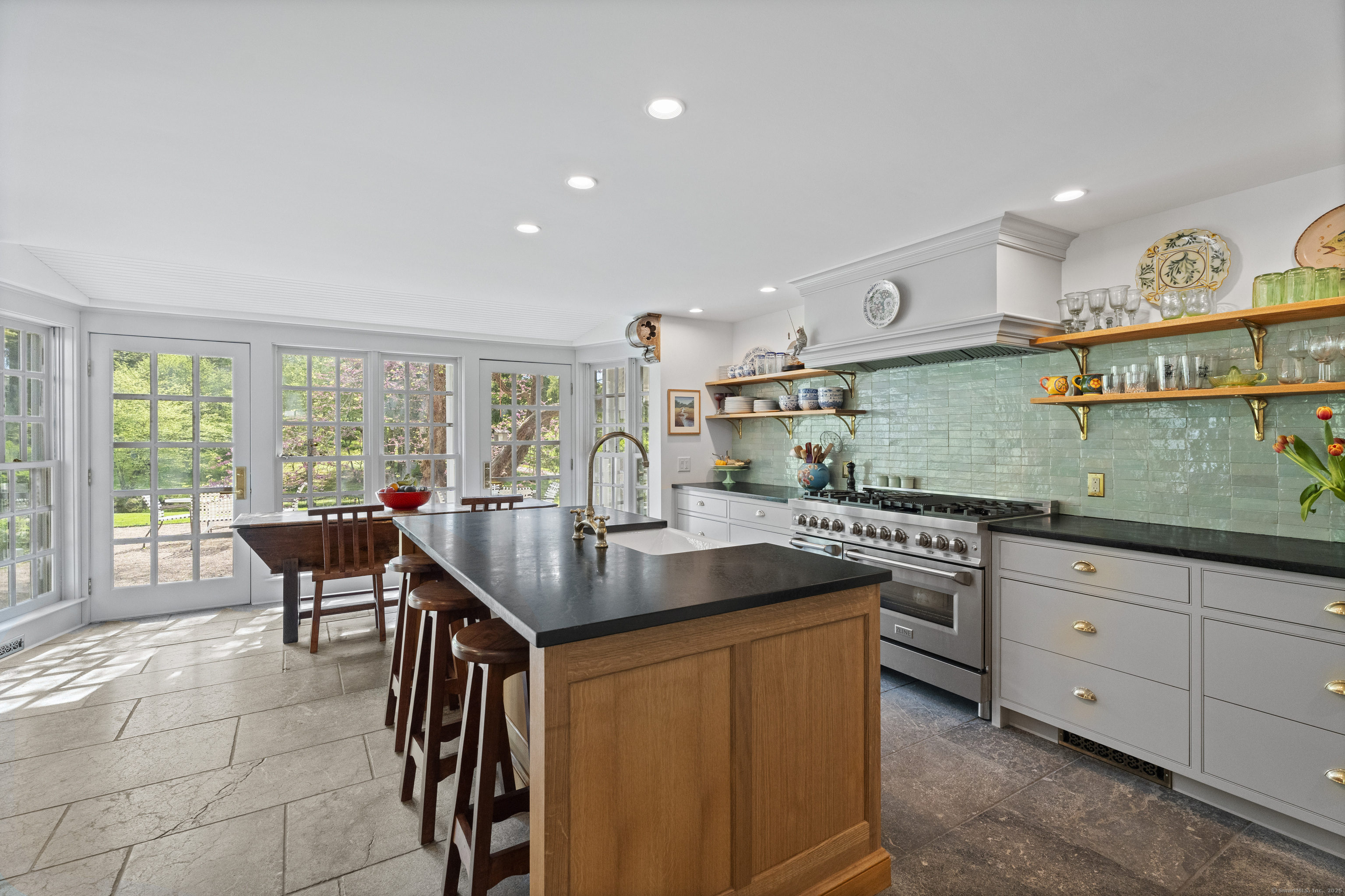 38 Three Bridges Road East Haddam, CT 06423 - Photo 5 of 39 a kitchen with a stove a sink a dining table and chairs