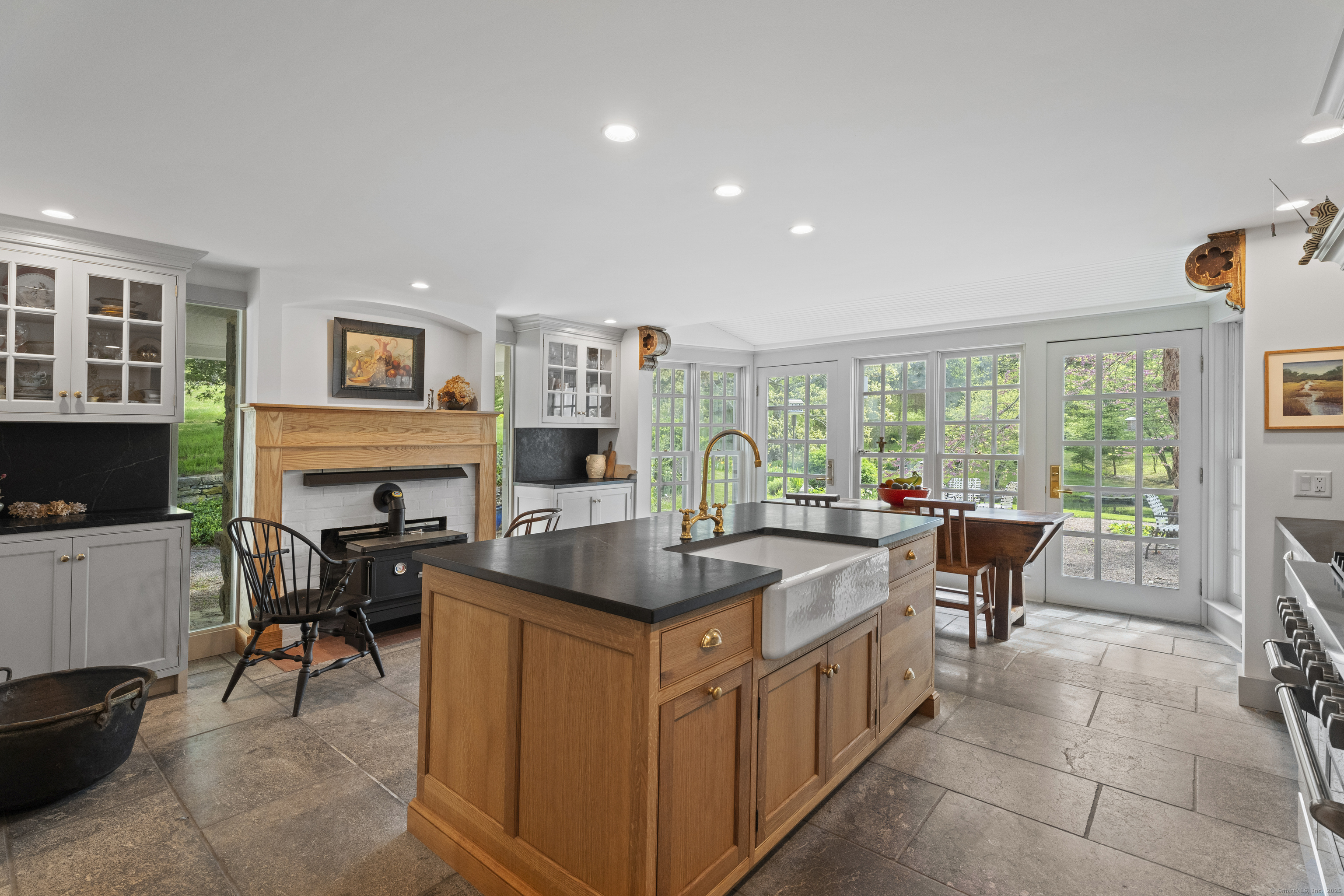 38 Three Bridges Road East Haddam, CT 06423 - Photo 7 of 39 a kitchen with a table chairs refrigerator and a stove top oven