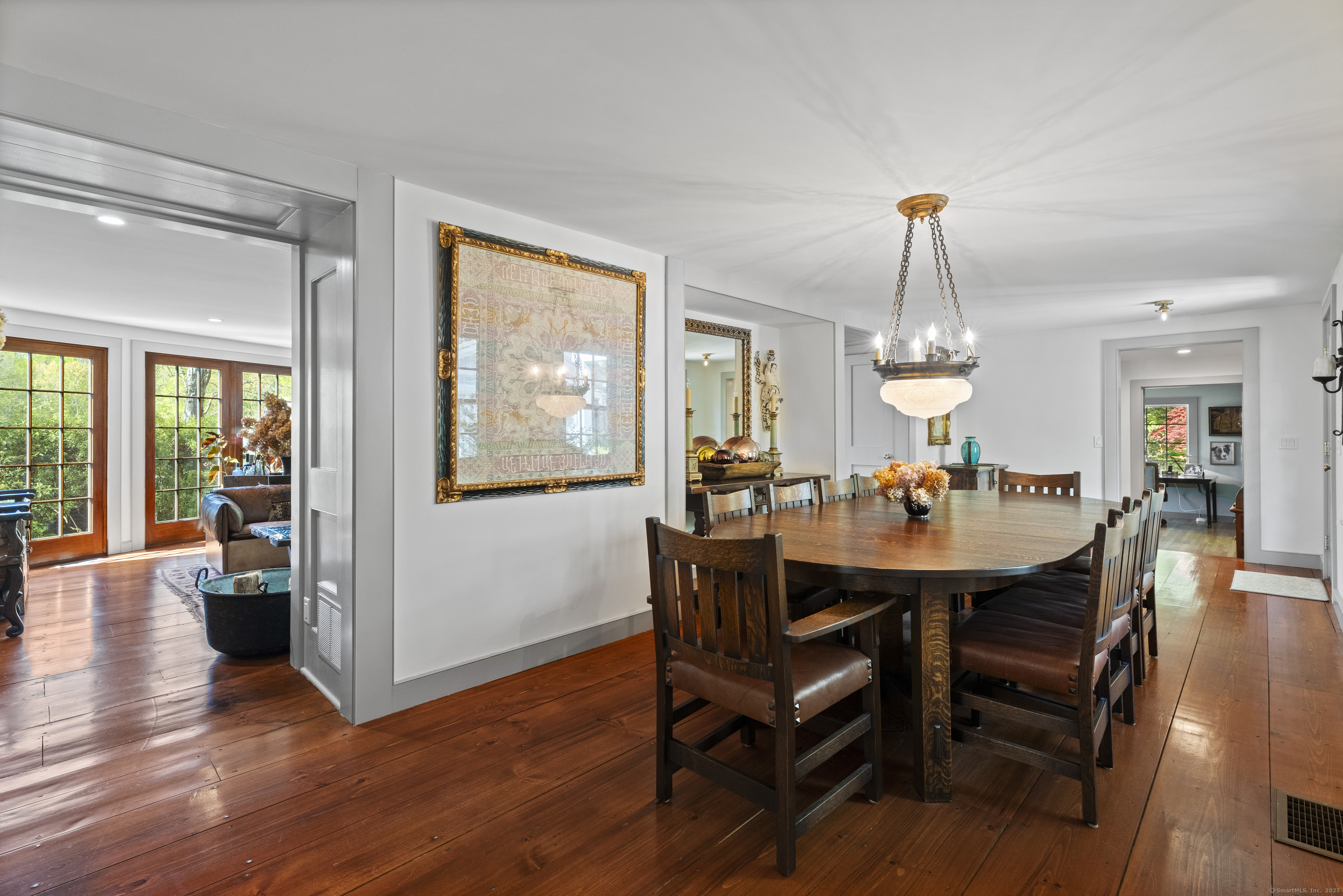 38 Three Bridges Road East Haddam, CT 06423 - Photo 9 of 39 a view of a dining room and livingroom with furniture wooden floor a rug a potted plant and a chandelier
