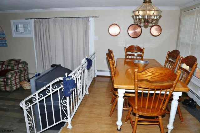 a view of a dining room with furniture and chandelier