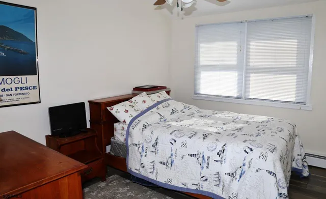 a bedroom with a bed and flat screen tv
