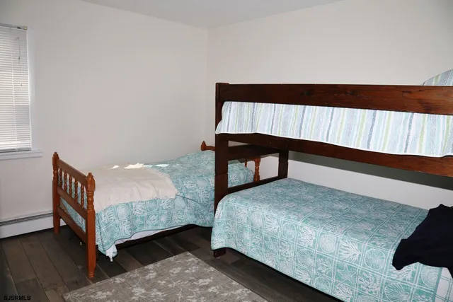 a bedroom with a bed and a night stand