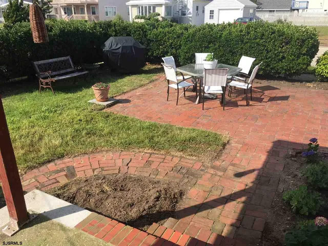 a view of a backyard with sitting area