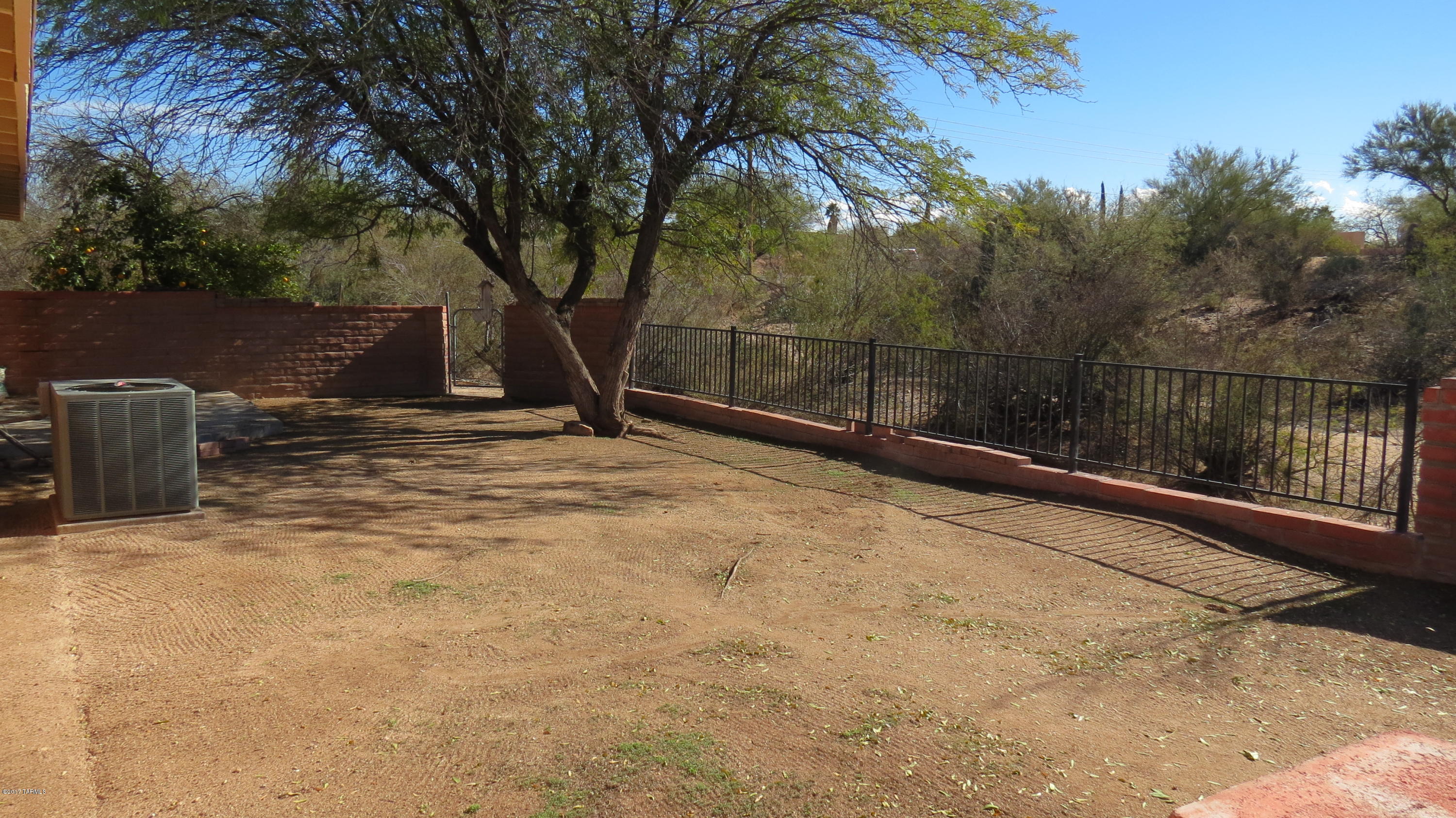 6601 North Mona Lisa Road Tucson, AZ 85741 - Photo 21 of 23 a backyard of a house with lots of green space and trampoline
