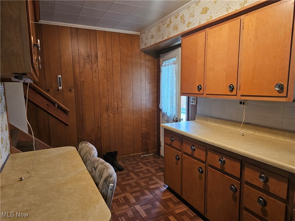2415 Columbiana Road New Springfield, OH 44443 - Photo 14 of 25 Kitchen featuring dark parquet flooring, ornamental molding, and wooden walls
