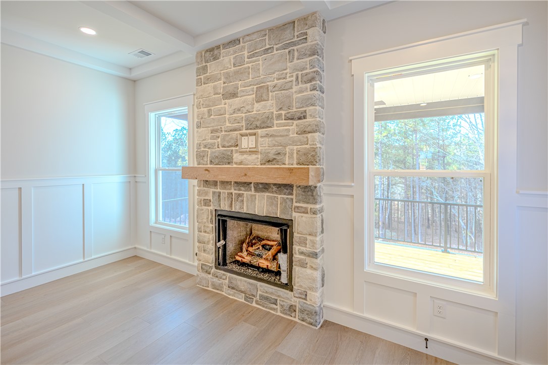 1409 Stonehurst Road Anderson, SC 29621 - Photo 25 of 36 This inviting room features a prominent stone fireplace, perfect for cozy gatherings and tranquil evenings.