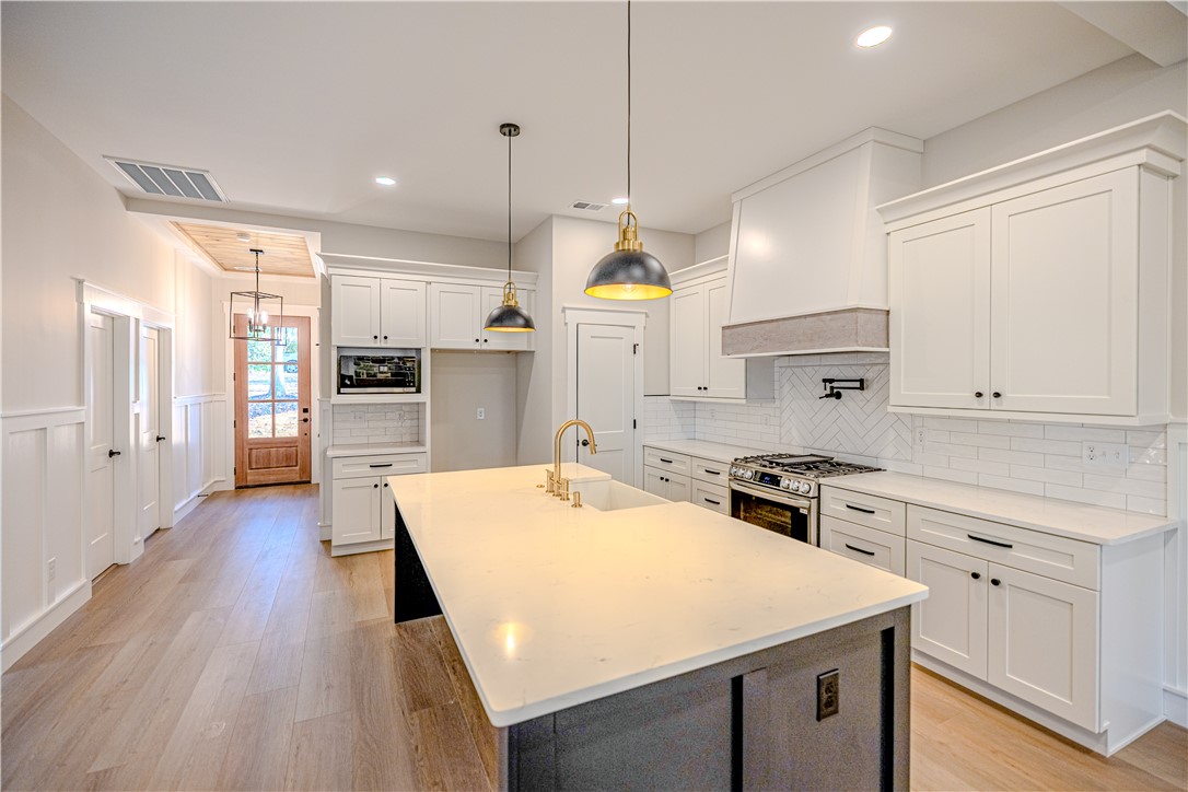 1409 Stonehurst Road Anderson, SC 29621 - Photo 28 of 36 This spacious kitchen features an expansive island and pristine white cabinetry, perfect for culinary endeavors.