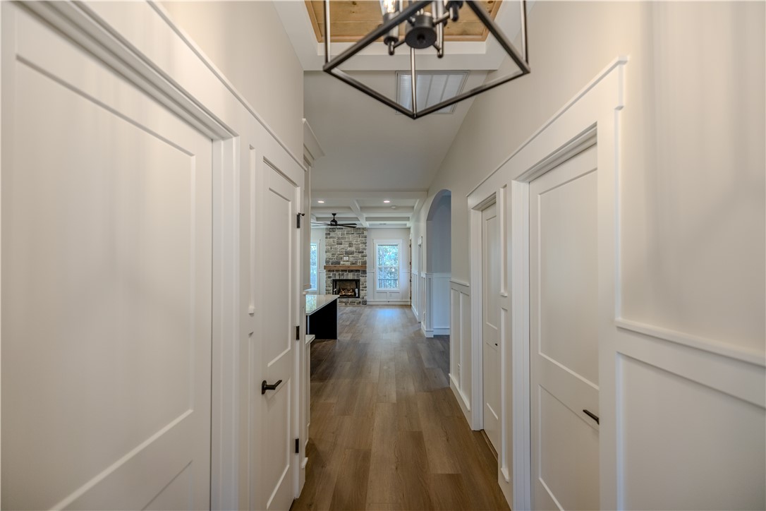1409 Stonehurst Road Anderson, SC 29621 - Photo 30 of 36 This inviting hallway features sleek flooring and leads to an open living area with a captivating fireplace.