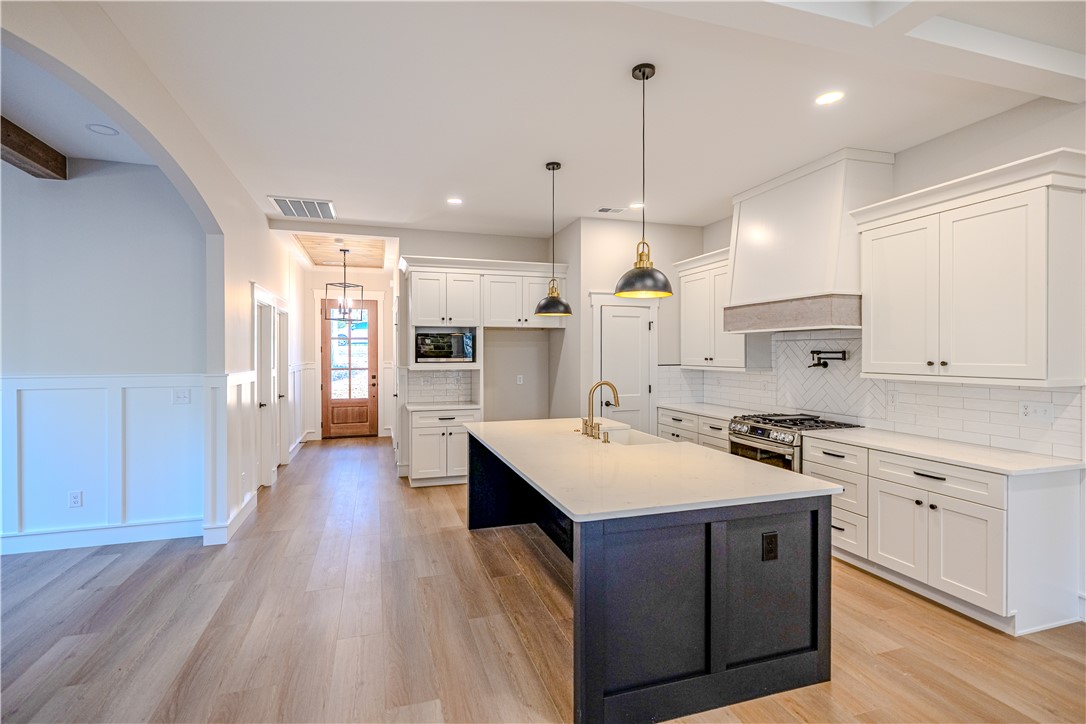1409 Stonehurst Road Anderson, SC 29621 - Photo 5 of 36 This spacious kitchen offers a large island, bright cabinetry, and ample counter space for culinary creativity.