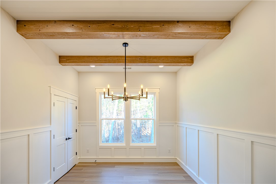 1409 Stonehurst Road Anderson, SC 29621 - Photo 7 of 36 This bright room features elegant wainscoting and natural wood beams.