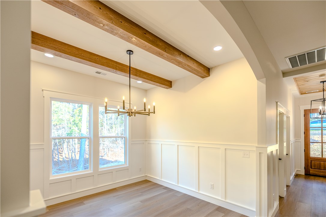1409 Stonehurst Road Anderson, SC 29621 - Photo 8 of 36 This bright room features a chandelier, recessed lighting, and hardwood flooring.