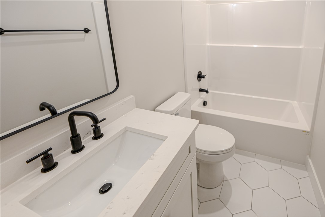 1409 Stonehurst Road Anderson, SC 29621 - Photo 9 of 36 This modern bathroom features a sleek vanity and a classic tub, perfect for daily routines.