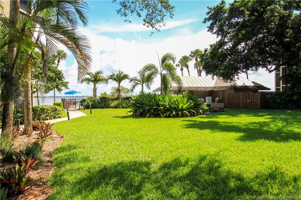 4440 Northeast Sandpebble Trace, Unit 403 Jensen Beach, FL 34957 - Photo 13 of 31 a view of a house with a big yard