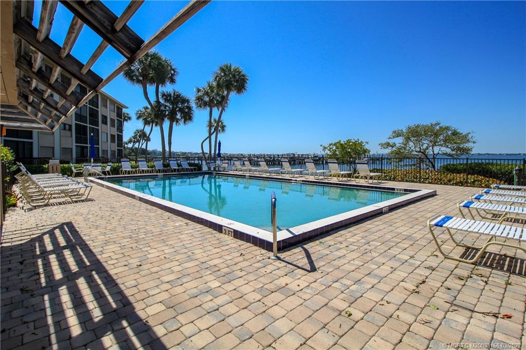 4440 Northeast Sandpebble Trace, Unit 403 Jensen Beach, FL 34957 - Photo 15 of 31 a view of swimming pool with chairs