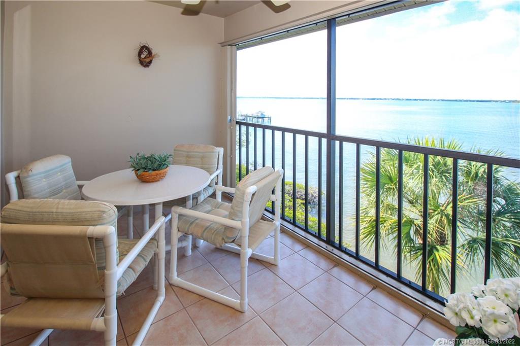 4440 Northeast Sandpebble Trace, Unit 403 Jensen Beach, FL 34957 - Photo 16 of 31 a view of a chairs and table in the balcony