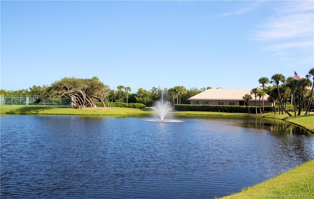 4440 Northeast Sandpebble Trace, Unit 403 Jensen Beach, FL 34957 - Photo 25 of 31 a view of a lake with houses