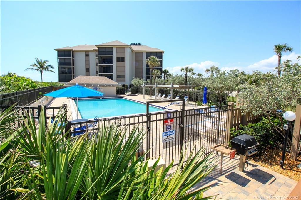 4440 Northeast Sandpebble Trace, Unit 403 Jensen Beach, FL 34957 - Photo 27 of 31 a view of a patio with swimming pool