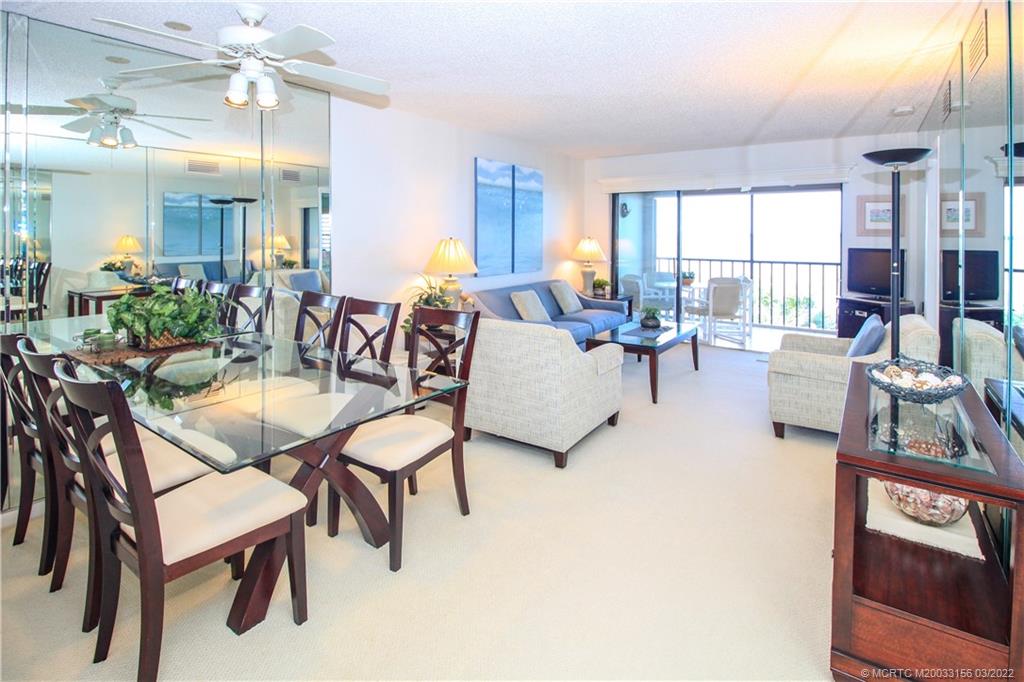4440 Northeast Sandpebble Trace, Unit 403 Jensen Beach, FL 34957 - Photo 3 of 31 a living room with furniture and a large window