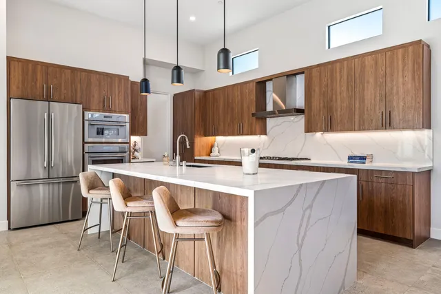a kitchen with a sink refrigerator and cabinets