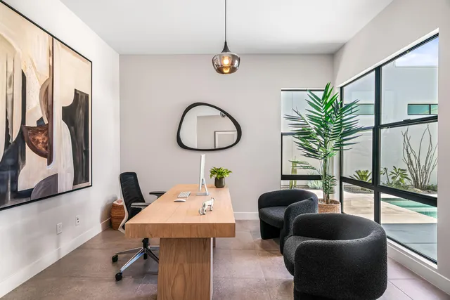 a living room with furniture and a floor to ceiling window