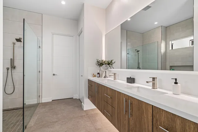 a bathroom with a double vanity sink mirror and double