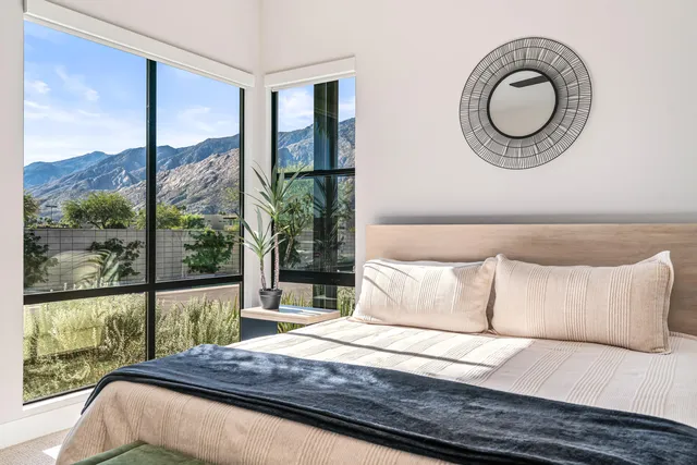 a bedroom with a large bed and a large window