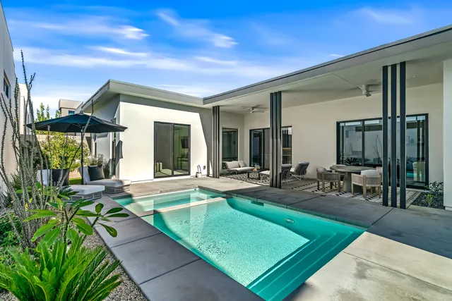 a view of a house with backyard porch and sitting area