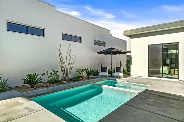 a swimming pool with outdoor seating