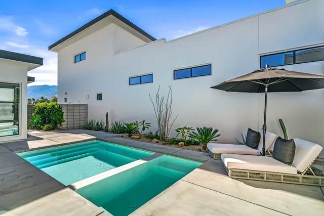 a front view of a house with yard and patio