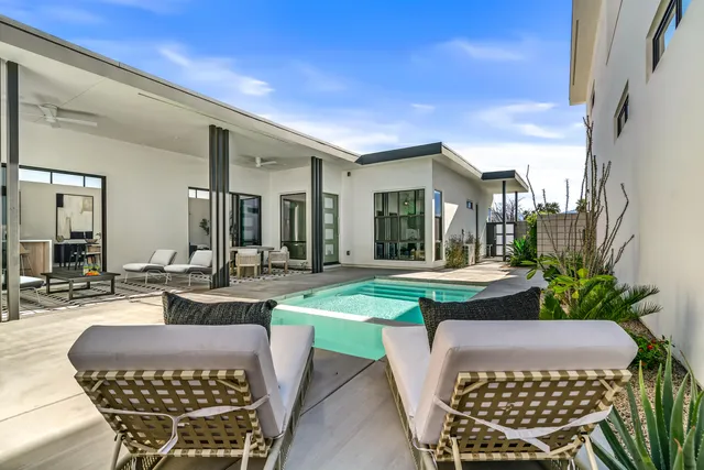 a view of a patio with couches table and chairs