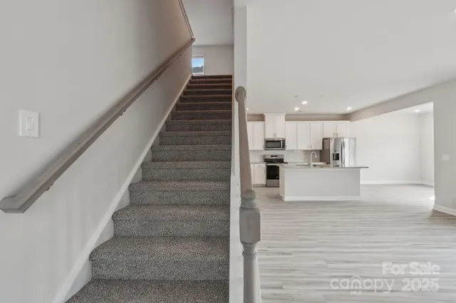 a view of kitchen with wooden floor and electronic appliances