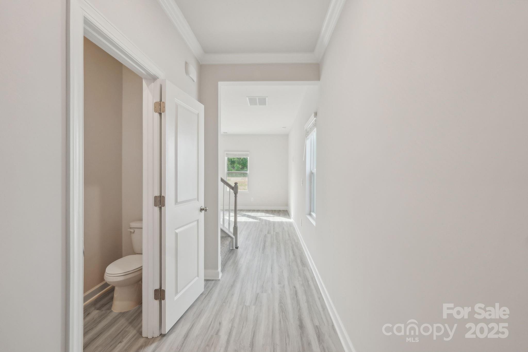 1321 30th St Lane Northeast Conover, NC 28613 - Photo 26 of 27 a view of a hallway with wooden floor and a bathroom
