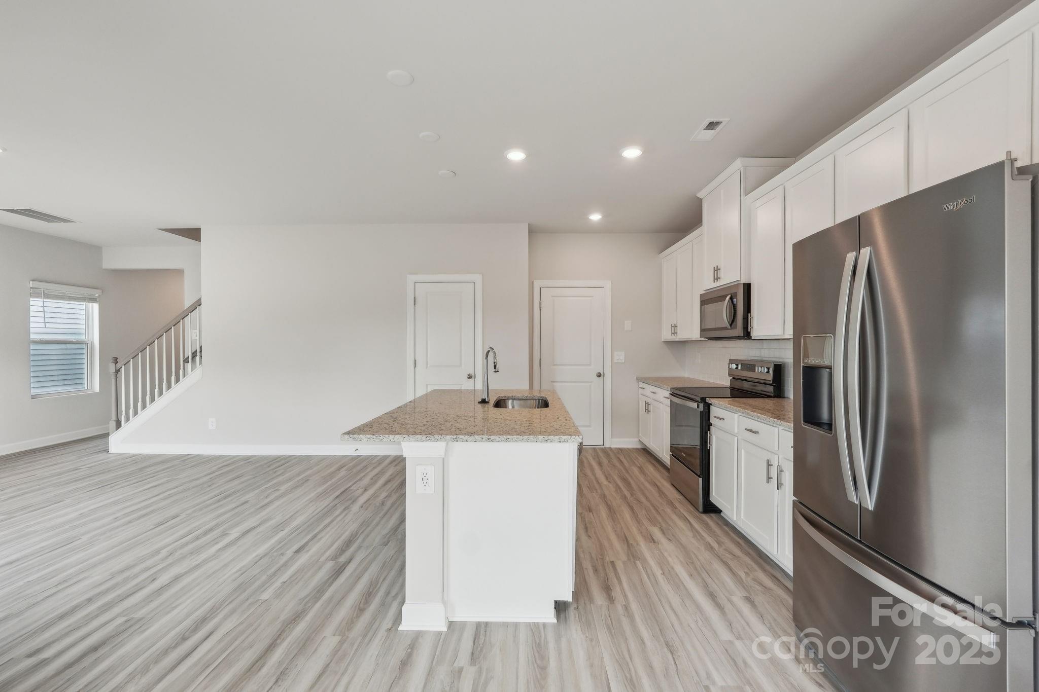 1321 30th St Lane Northeast Conover, NC 28613 - Photo 10 of 27 a kitchen with stainless steel appliances a refrigerator sink and stove