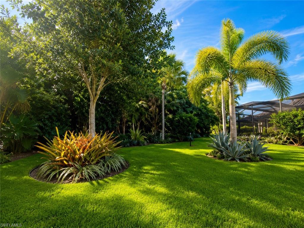 6574 Amarone Lane Naples, FL 34113 - Photo 29 of 44 a view of a backyard with a garden