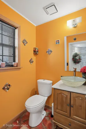 a bathroom with a sink a toilet and mirror