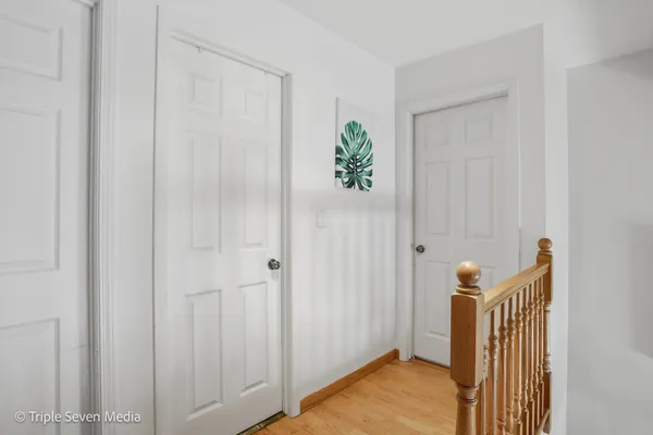 a view of a room with wooden floor and entryway