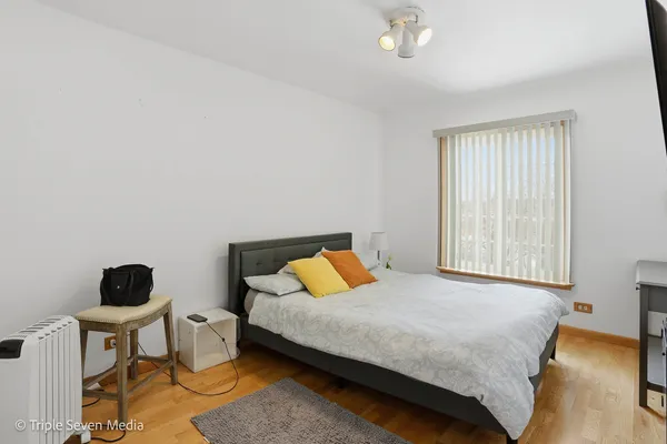 a bedroom with a bed and a chair