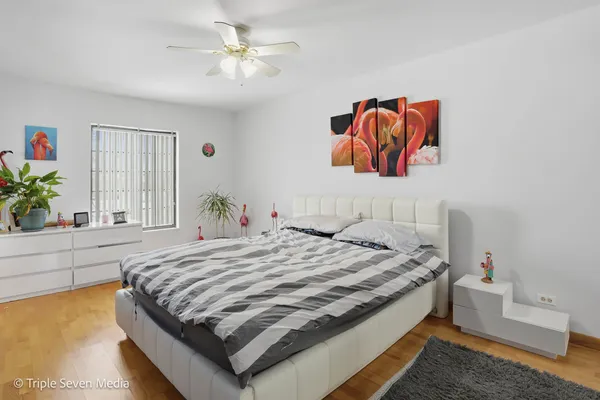 a bedroom with a bed and a chandelier