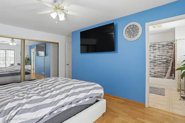 a bedroom with a bed and a flat screen tv