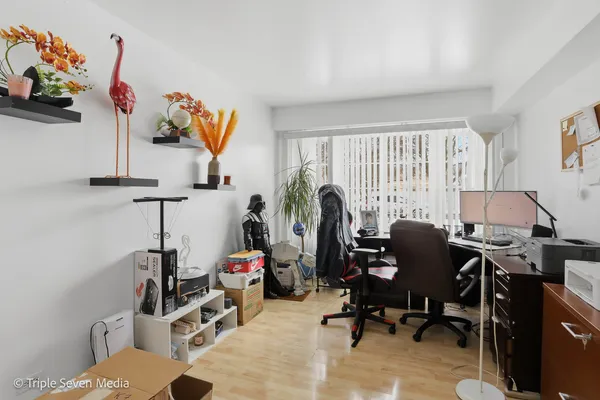 a view of a workspace with furniture and a window