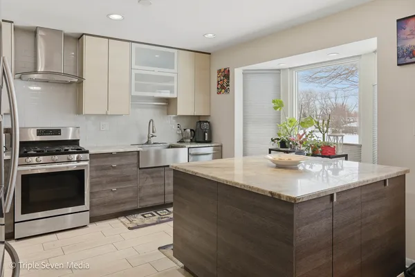 a kitchen with a sink stove and refrigerator