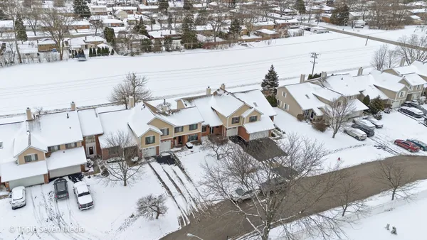 a view of a house with a snow in the yard