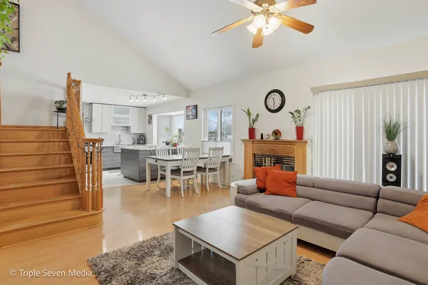a living room with furniture a fireplace and a table