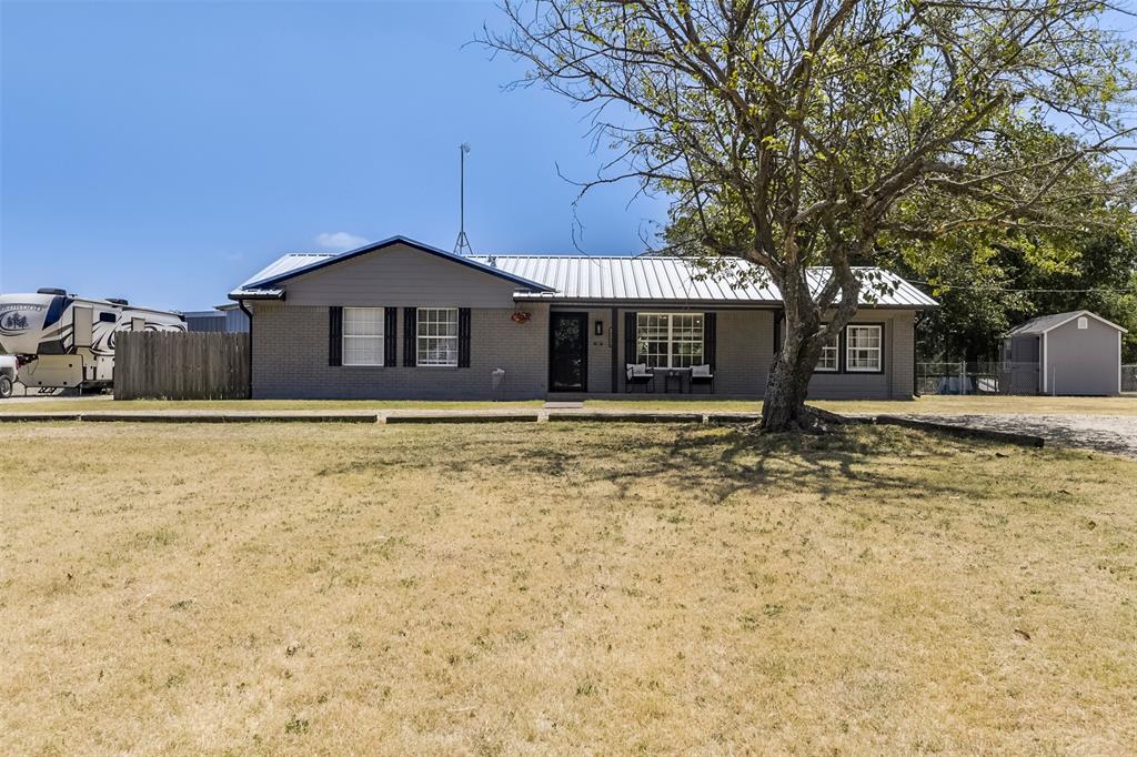 472 Cox Road Waxahachie, TX 75167 - Photo 2 of 31 Single-story residence featuring a metal roof, brick exterior, and a covered front porch