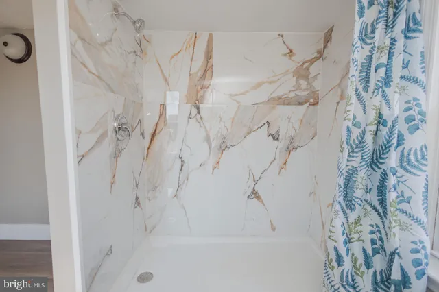 a bathroom with a bathtub and shower