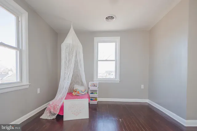 an empty room with wooden floor and closet